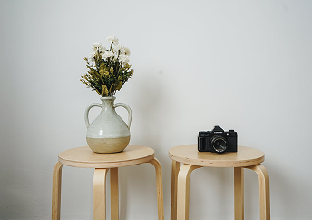 Dining table by a brick wall with bright sunlight